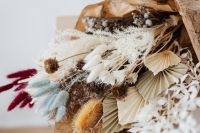 Kaboompics - Neutral Boho Bouquet of Pampas Grass and Folded Dried Palm Leaves in Kraft Paper