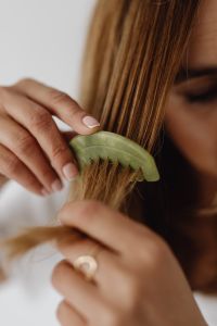 Kaboompics - Woman Combing Long Hair with a Green Jade Comb