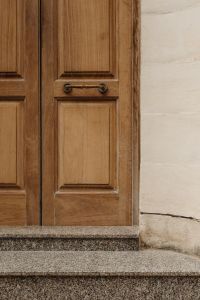Kaboompics - Natural Wood Double Door with Traditional Pull Handles