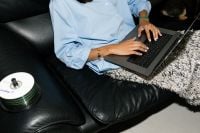 Kaboompics - Flash Photography Aesthetic of Woman Working on Laptop on Black Leather Sofa