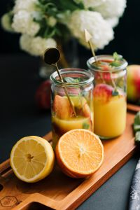 Kaboompics - Fresh Citrus and Peach Drinks with Sliced Oranges on a Serving Board, Summer Recipe Content