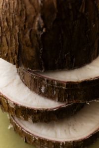Kaboompics - Cut Coconut with Brown Shell on Olive Green Background