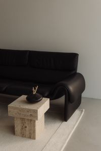 Kaboompics - Black Leather Sofa and Travertine Coffee Tables