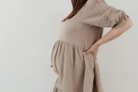 Kaboompics - Pregnant Woman Holding Ultrasound Photos Over Her Belly