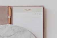 Kaboompics - Lined Notepad and Rose Gold Pen on Marble for Productivity and Desk Design