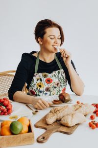 Kaboompics - Woman Tasting a Slice of Cheese