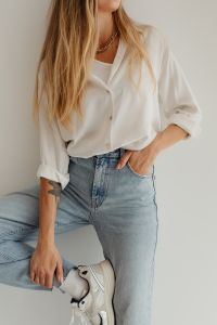 Kaboompics - Blonde Woman in Loose White Button-Down over Tank Top, Light Blue Denim Outfit