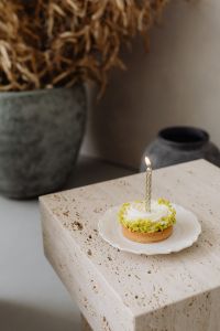 Kaboompics - Close-Up Small Cake with a Candle on a Stone Table