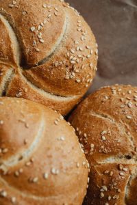 Kaboompics - Close-Up of Sesame-Topped Kaiser Roll Buns with Crisp Scored Crusts