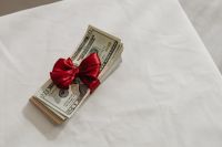 Kaboompics - Cash Gift with Red Ribbon Background