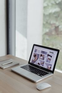 Kaboompics - Close-Up of Laptop Keyboard and Screen at a Wooden Desk beside a Pencil Cup