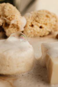 Kaboompics - Close-Up of White Soap Bar with Bubble and Sea Sponges