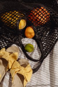 Kaboompics - Mesh Beach Bag Filled with Citrus and Summer Essentials