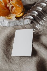 Kaboompics - Portrait Card Mockup with Orange Peel and Sculptural Glass Vases