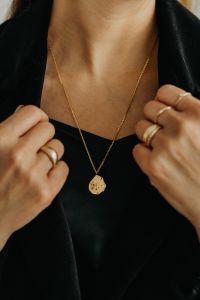 Kaboompics - Woman Opening Black Blazer to Show Gold Necklace