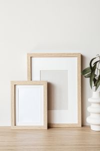 Kaboompics - Blank Wooden Frame Mockup with Hourglass for Neutral Poster Design
