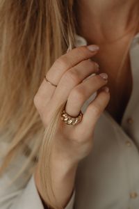 Kaboompics - Woman's Hand in Hair Wearing Gold Ring