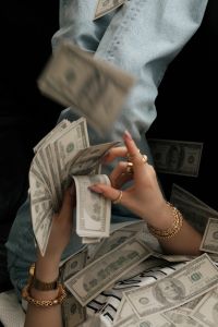 Kaboompics - Dollar Bills Falling Over Woman Lying on a Sofa