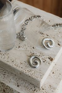 Kaboompics - Silver Earrings, Chain and Spiral Earrings on Stone