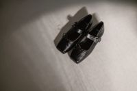 Kaboompics - Black Buckled Slingback Shoes on Neutral Floor