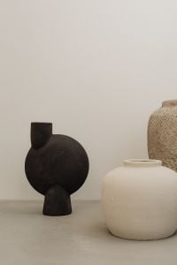 Kaboompics - Black and Textured Beige Ceramic Vases Against Neutral Wall