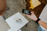 Kaboompics - Overhead Hand Holding Smartphone with Black Wristwatch