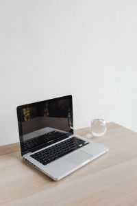 Kaboompics - Laptop and Glass of Water on Desk with Copy Space