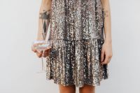 Kaboompics - Silver Sequin Dress and Champagne Flute Held at Waist