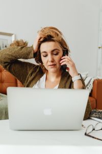 Kaboompics - Woman Taking a Work Call While Using a Laptop at Home