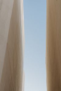 Kaboompics - Minimal Stone Architecture with Narrow Opening and Blue Sky