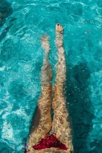 Kaboompics - A beautiful woman in a pool with an inflatable ring