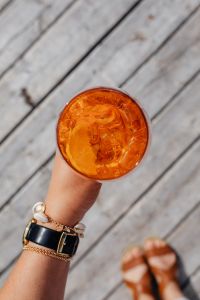 Kaboompics - Top-Down Aperol Spritz with Watch and Sandals on White Pier Boards