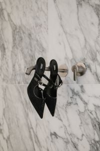 Kaboompics - Black Pointed Slingback Heels by Marble Wall