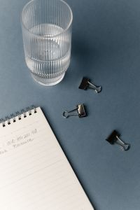 Kaboompics - Workspace Flat Lay With Notebook Glass And Office Clips