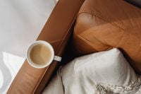 Kaboompics - Overhead Coffee Break on Leather Sofa with Soft Knit Blanket for Neutral Lifestyle Content