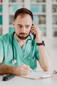 Kaboompics - Doctor Speaking by Phone in Office Portrait