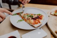 Kaboompics - Serving a Pizza Slice Beside a Whole Pizza at the Table