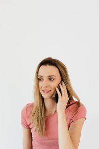 Kaboompics - Woman Portrait in a Pink Top Against White Copy Space, Minimal Lifestyle Marketing Image