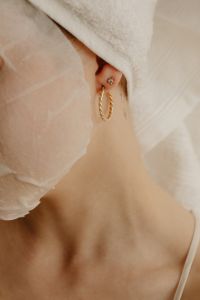Kaboompics - Close-Up of a Facial Sheet Mask and Gold Hoop Earring