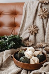 Kaboompics - Bowl of Paper Ornaments on Sofa with Evergreen Wreath