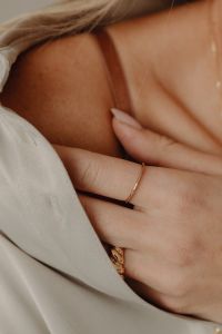 Kaboompics - Woman's Hand with Gold Rings on Tan Silk Shirt