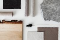 Kaboompics - White Surface with Rolled Textiles, Wood, and Stone Samples