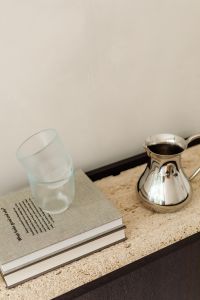 Kaboompics - Silver Pitcher and Clear Glass on Travertine Top