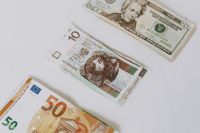 Kaboompics - Polish Zloty, US Dollar and Euro Banknotes on a White Surface