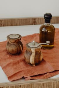 Kaboompics - Wooden Salt and Pepper Mills with Amber Oil Bottle, Warm Kitchen Counter Still Life