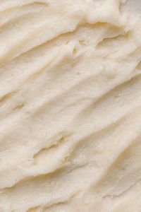 Kaboompics - Thick White Skincare Cream with Broad Diagonal Streaks, Neutral Macro Texture