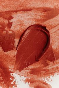 Kaboompics - Brown Lipstick Swatch on Coral Texture