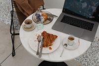 Kaboompics - Coffeehouse Work Table with Laptop, Pastries and Coffee