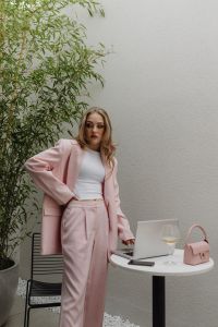 Kaboompics - Woman Standing Beside a Laptop and Wine Glass