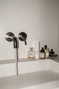 Kaboompics - Flash Photography of Perfume and Skincare by Sink Faucet